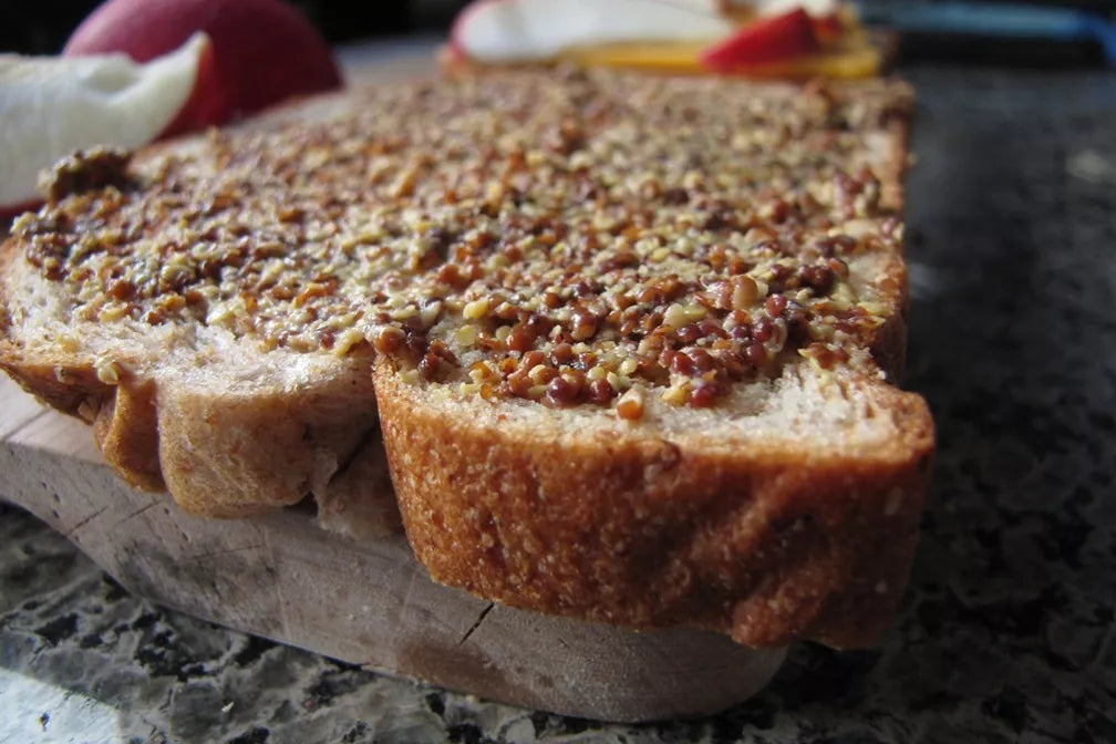 Slices of bread with a nutty spread on a wooden board