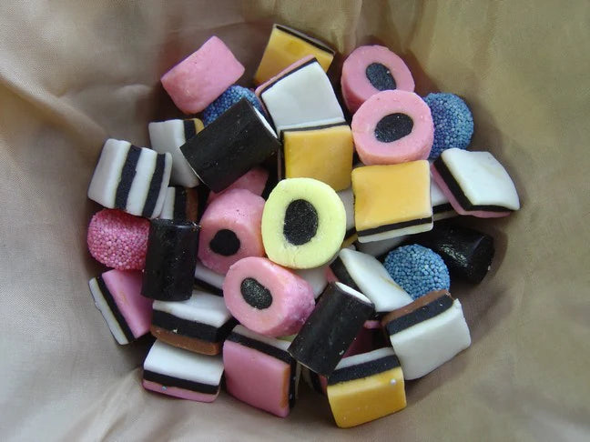 Assorted colorful candy pieces on a beige background