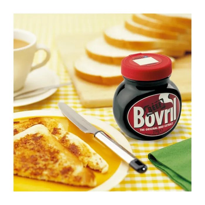 Jar of Bovril with toast and tea on a yellow checkered tablecloth