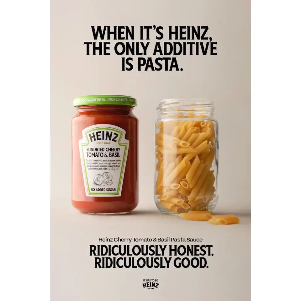Heinz tomato sauce jar with penne pasta on a light background, featuring brand text.