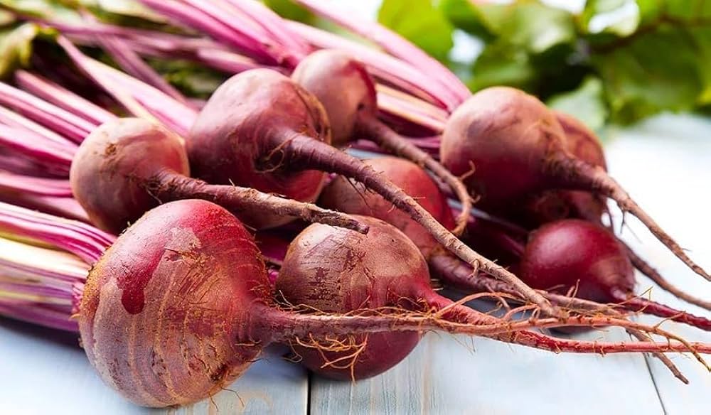 Bunch of red beets on a wooden surface