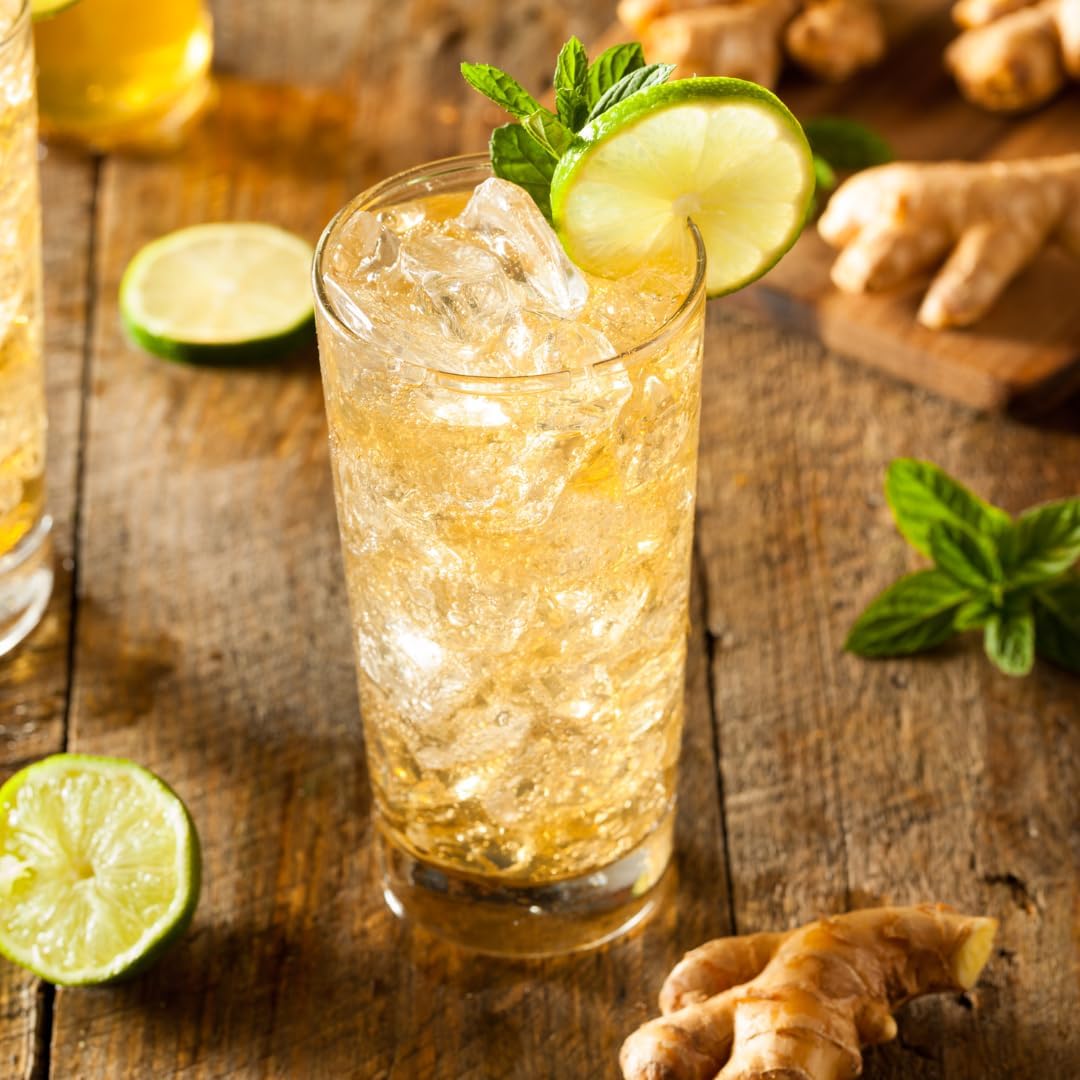 Ginger ale with lime and mint on a wooden surface