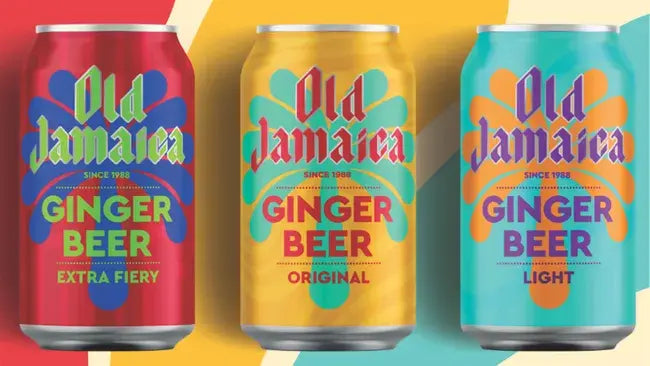 Three cans of Old Jamaica Ginger Beer in different flavors on a colorful background