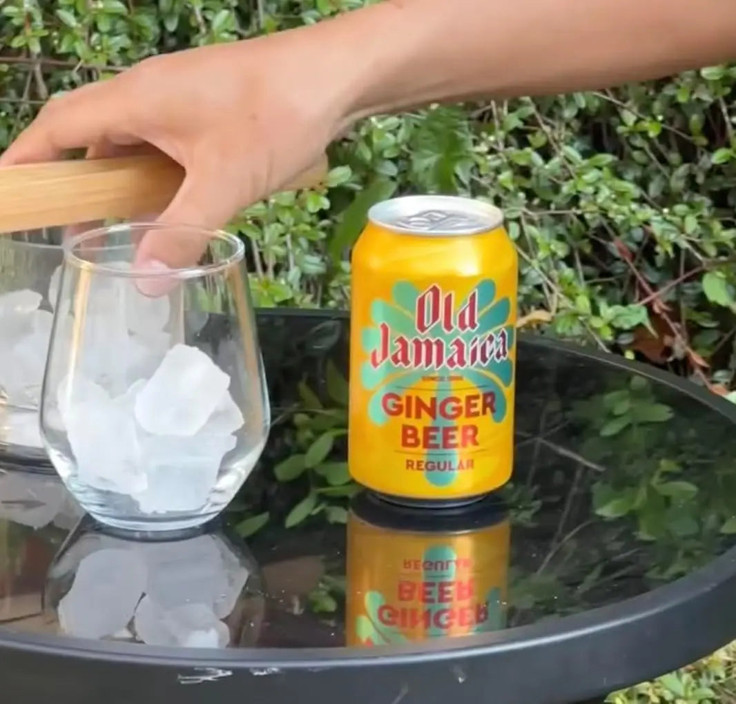 Can of Old Jamaica Ginger Beer on a table with a glass of ice.