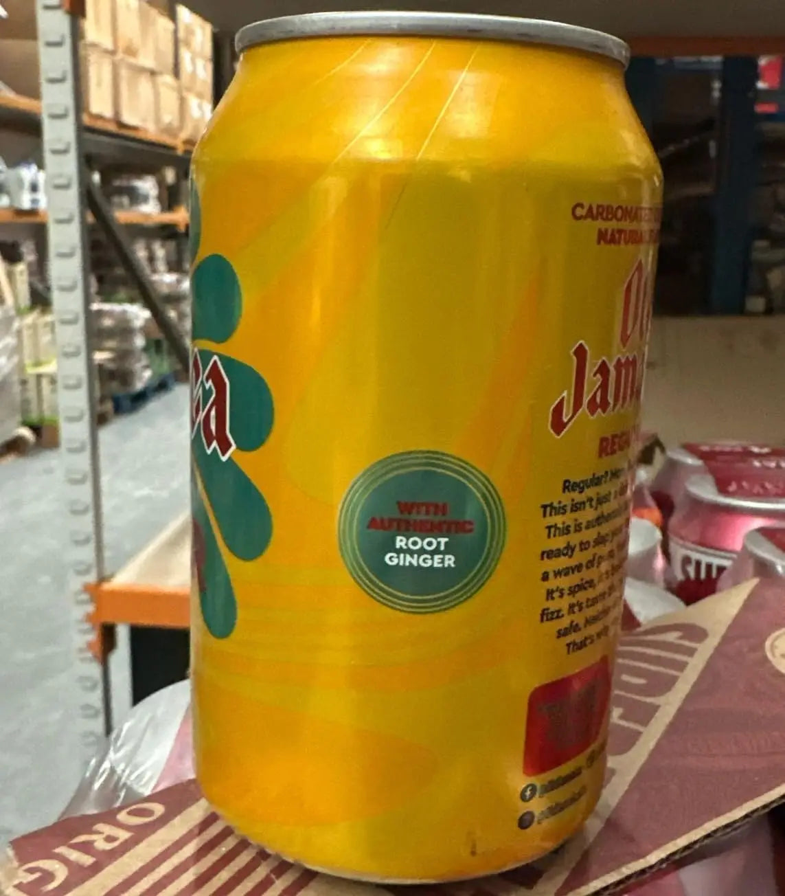 Yellow can with branding on a cardboard surface in an indoor setting