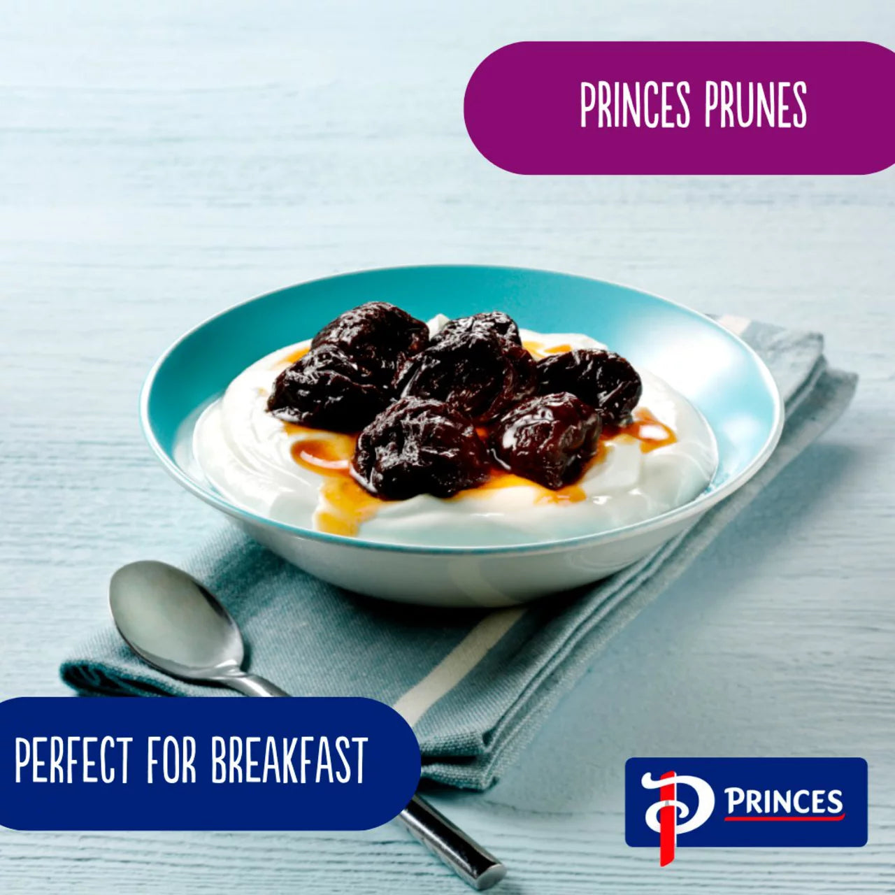 Bowl of yogurt with prunes on a light blue background, featuring Princes Prunes branding.