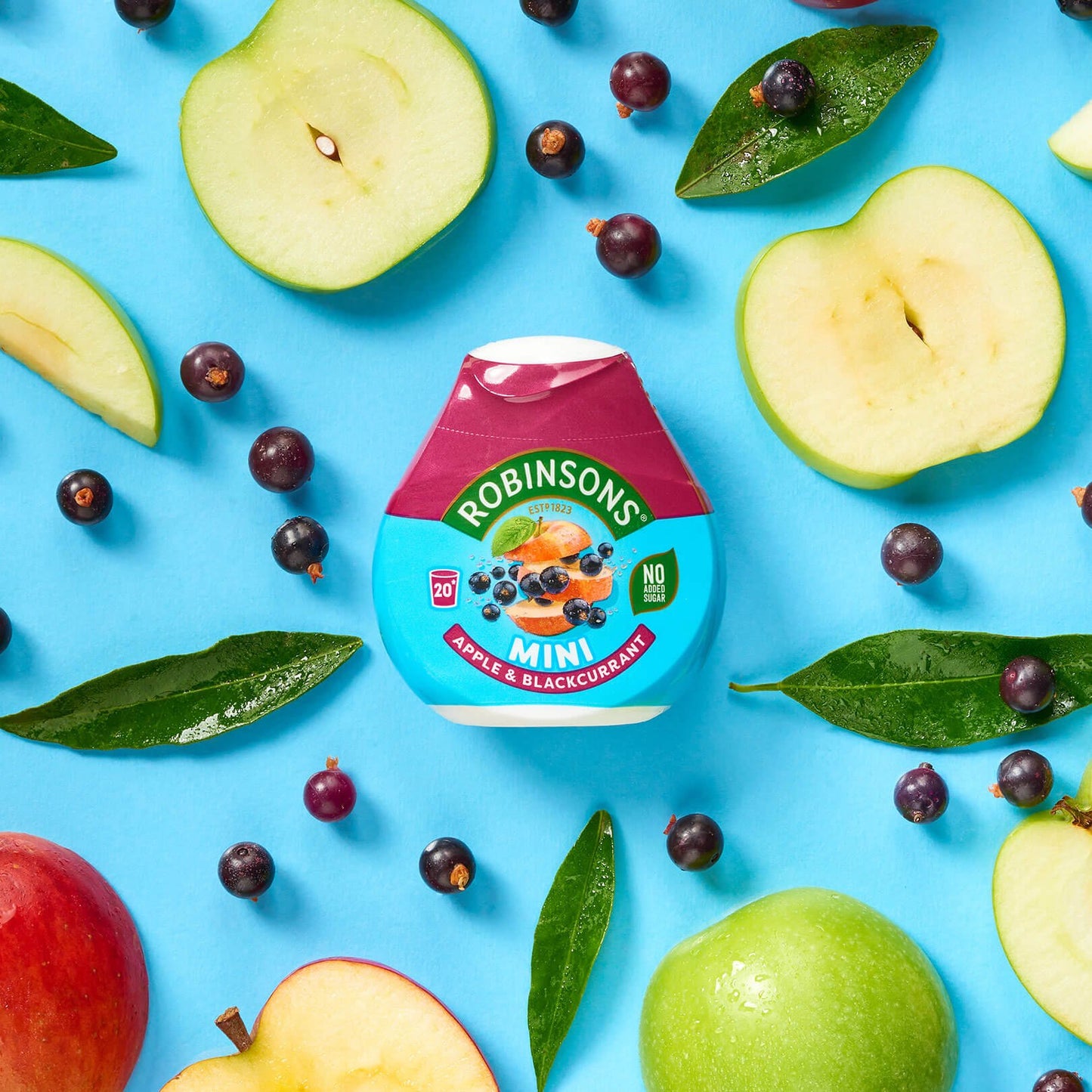 Robinsons jelly container surrounded by apples and berries on a blue background