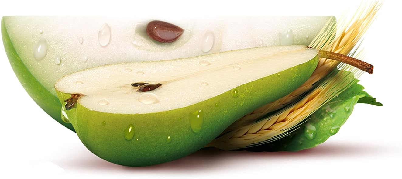 Green pear cut in half with seeds visible on a white background