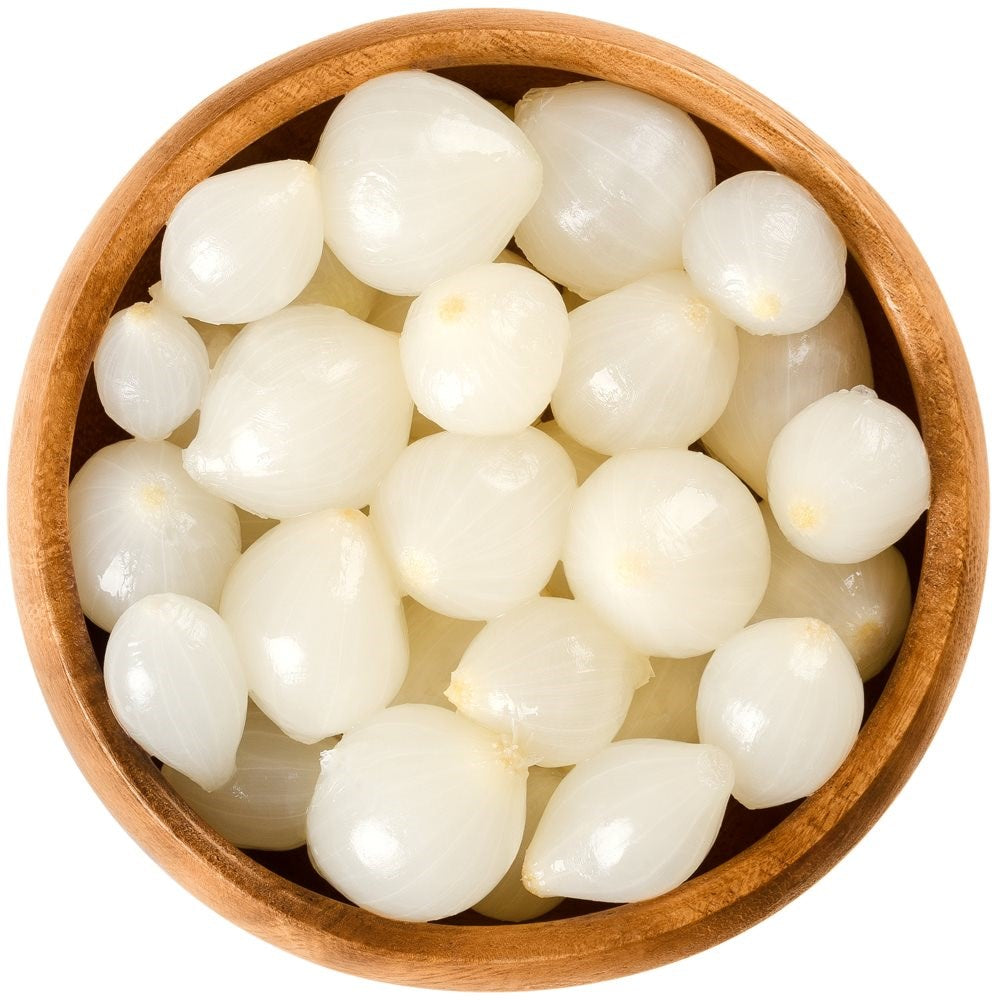 Wooden bowl filled with white pearls on a white background