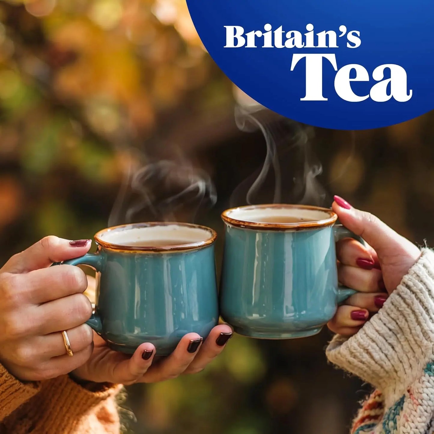 Two people holding steaming blue mugs with 'Britain's Tea' logo above.