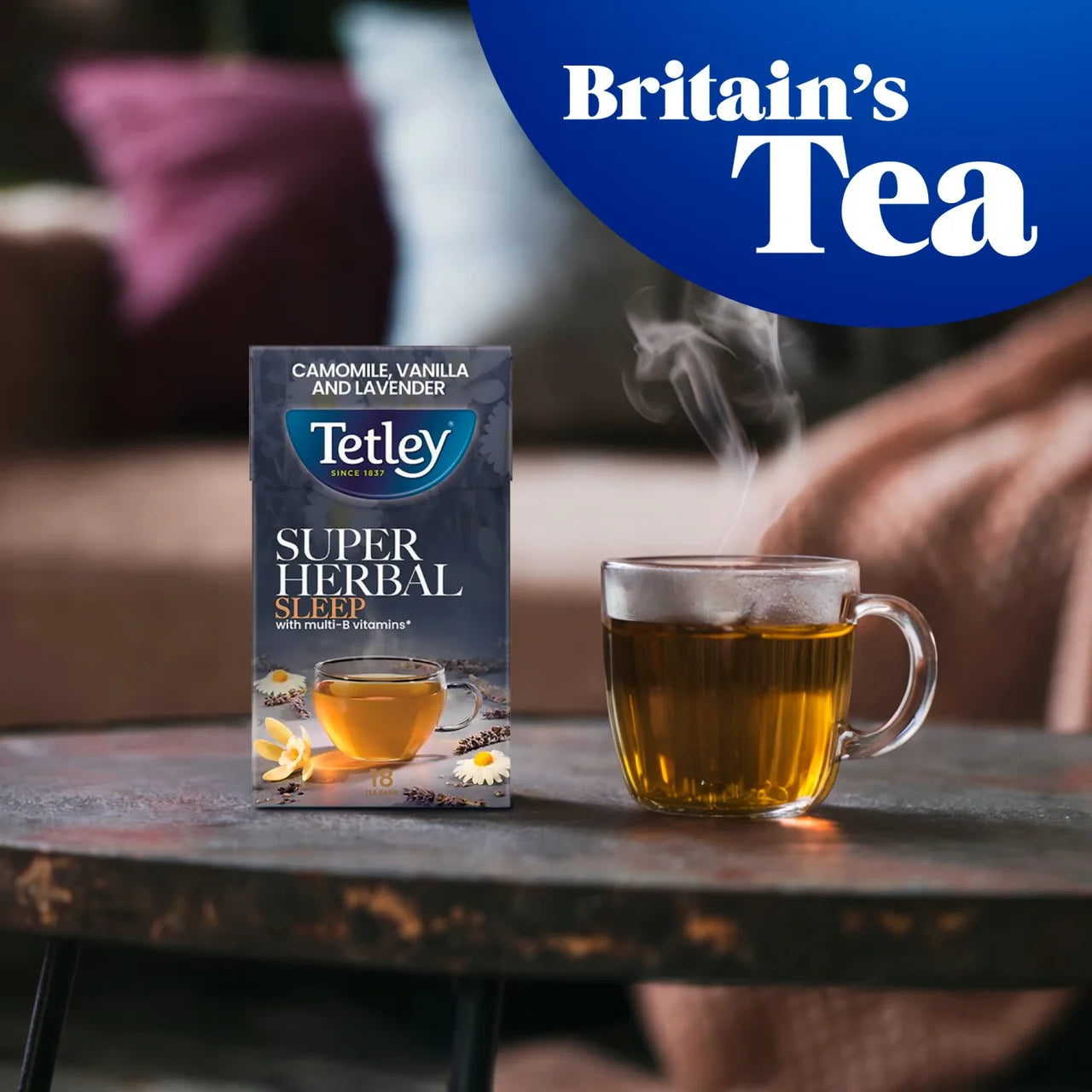 Tetley Super Herbal tea box with a steaming cup of tea on a table, featuring 'Britain's Tea' branding.