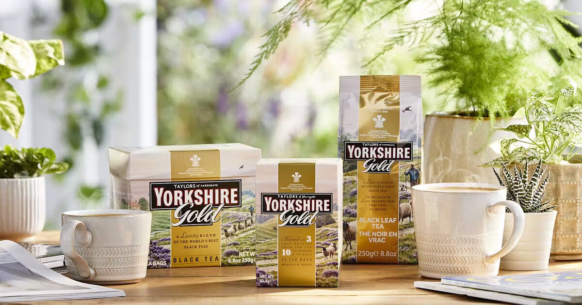 Yorkshire Gold tea packages on a table with a blurred natural background