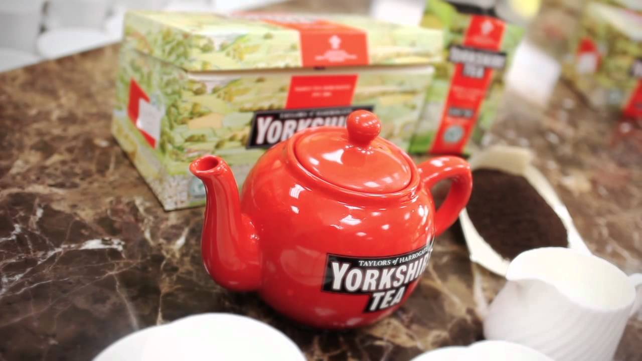 Red teapot with 'Yorkshire Tea' branding on a marble surface.