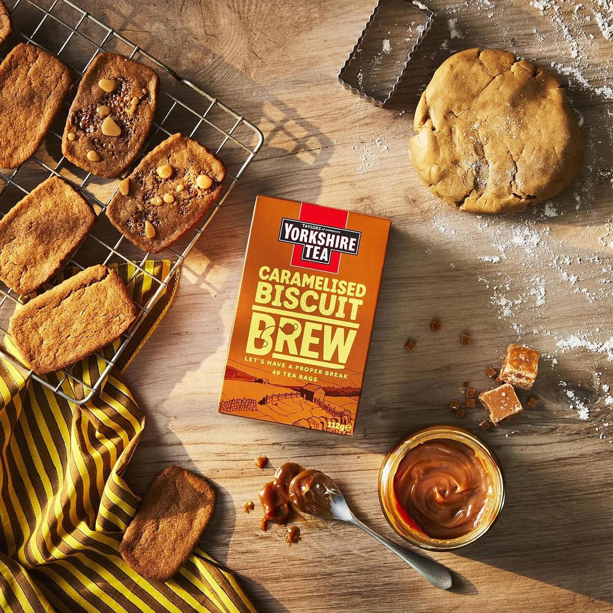 Yorkshire Tea Caramelised Biscuit Brew box with baked goods on a wooden surface