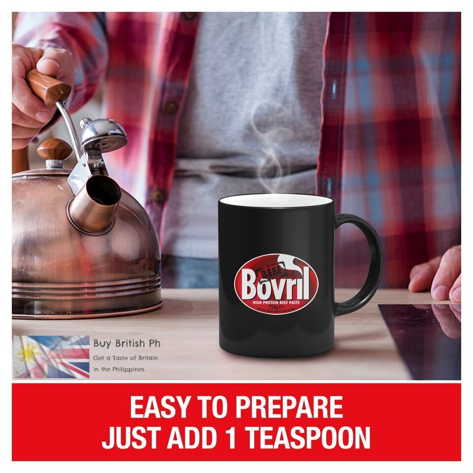 Person pouring tea into a Bovril mug with a kettle, set against a blurred background.