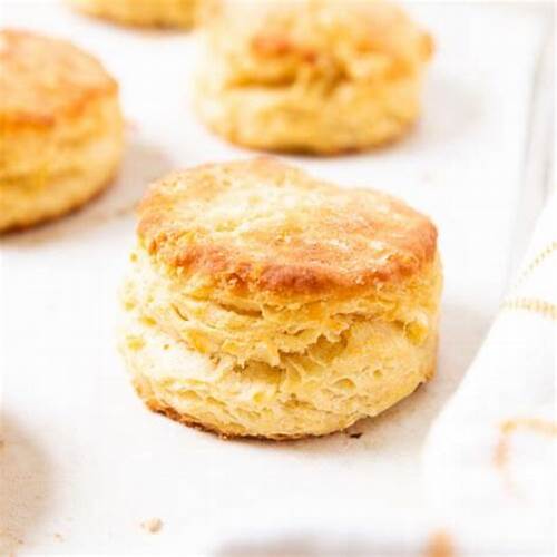 Close-up of a golden-brown biscuit on a white surface
