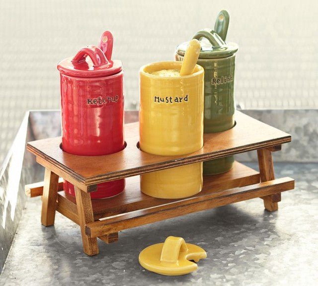 British dinner table condiments including mustard and sauces in ceramic pots