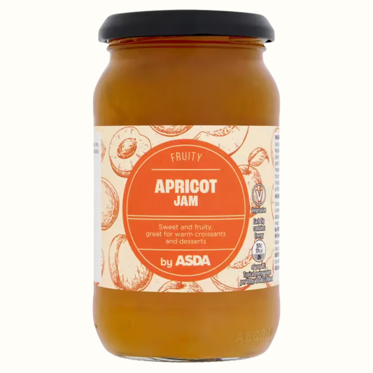 A glass jar of ASDA Fruity Apricot Jam with a black lid and a cream-colored label featuring orange illustrations of apricots and a large orange circular badge.