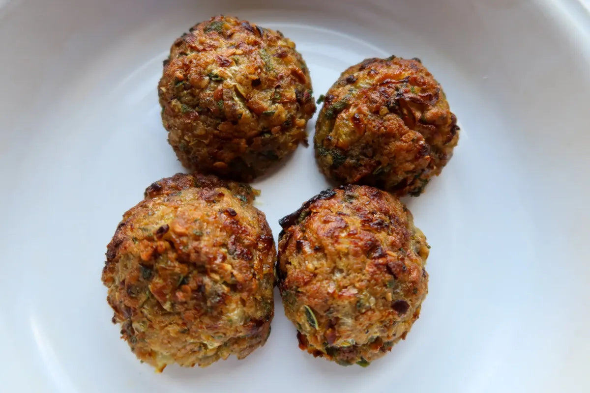 Four Sage and Onion Stuffing Balls on a white plate