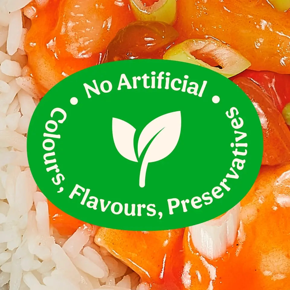 Close-up of food with a green label stating 'No Artificial Colours, Flavours, Preservatives' on a leaf background.