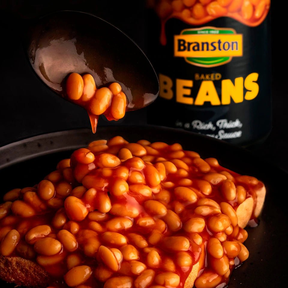 Baked beans on toast with a jar of Branston baked beans in the background.