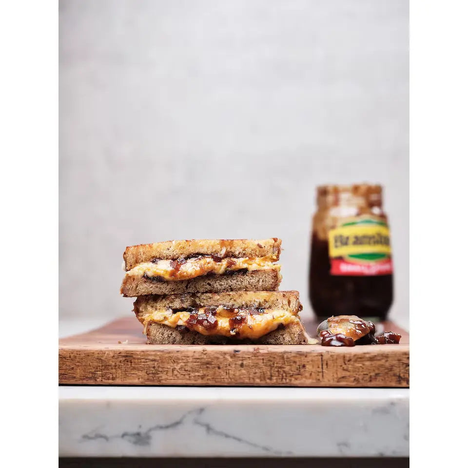 Branston Pickle Small Chunks sitting behind a Melted Cheese Sandwich