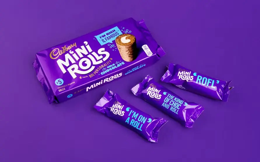 Cadbury Mini Rolls packaging on a purple background