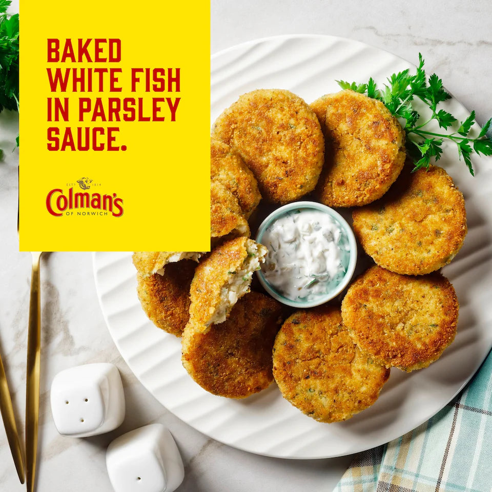 Baked white fish cakes on a plate with parsley and a sauce, featuring Colman's branding.