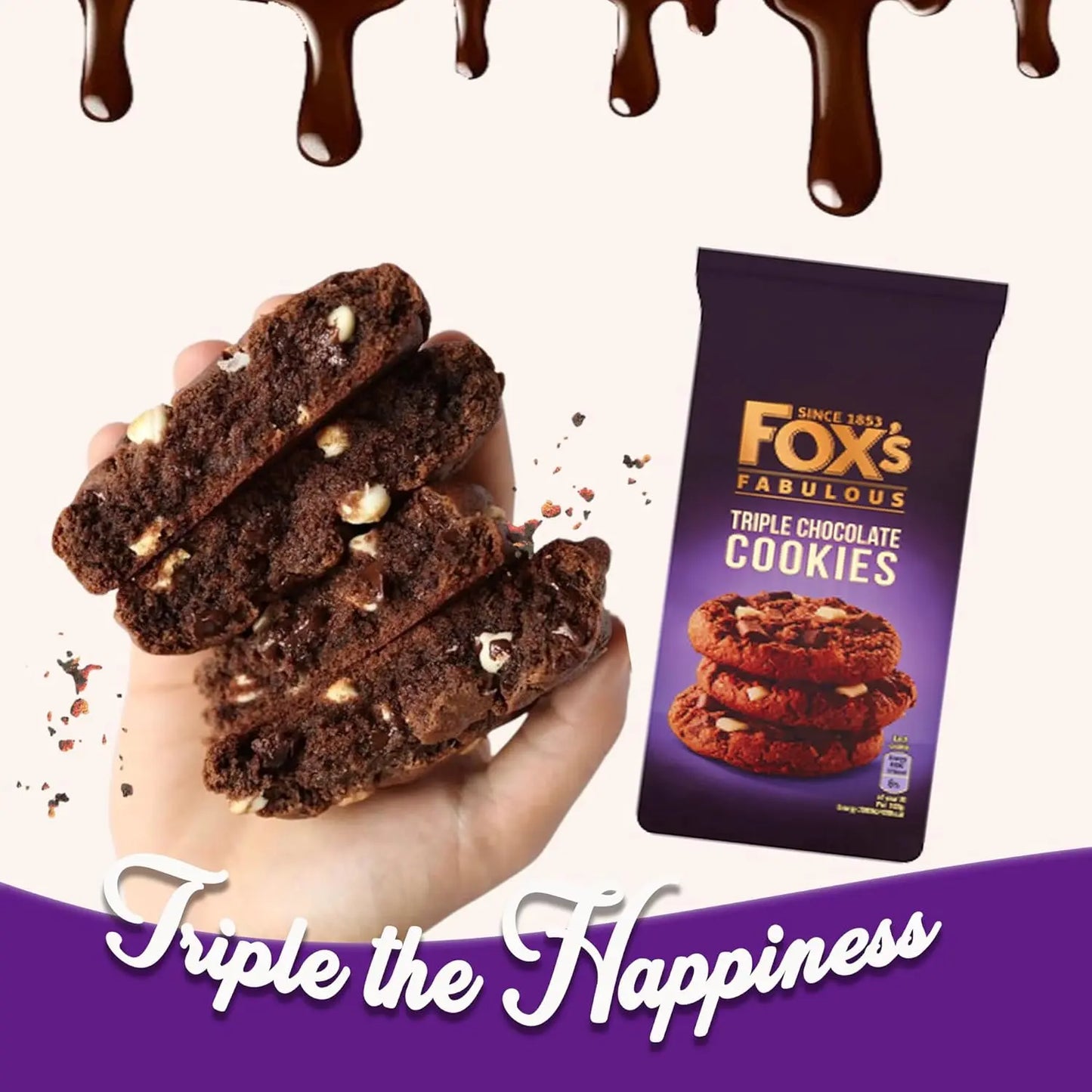 Hand holding Fox's Fabulous Triple Chocolate Cookies with packaging and chocolate drizzle on a white background.