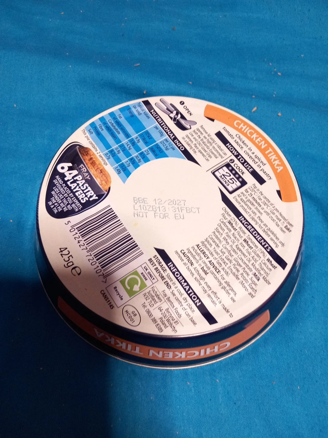 Round container lid with label on a blue background