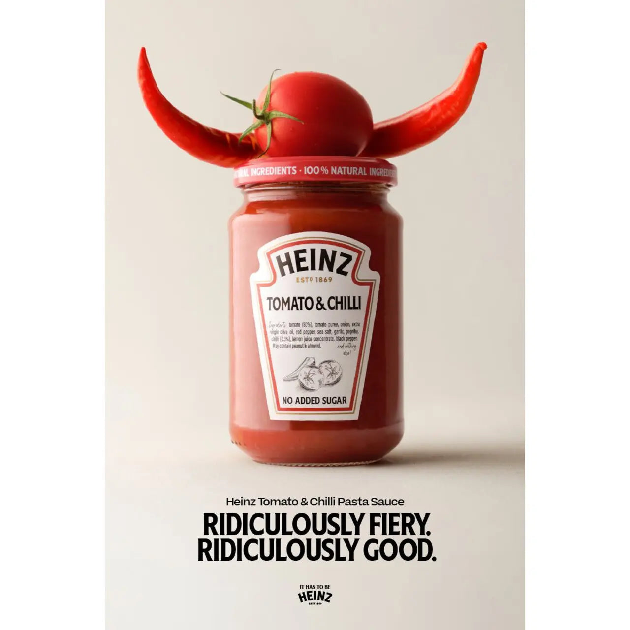 Heinz Tomato & Chilli Pasta Sauce jar with a red chili pepper on top against a beige background