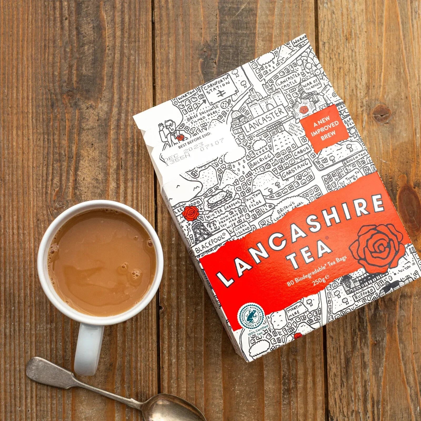 Lancashire Tea box with a cup of tea on a wooden surface