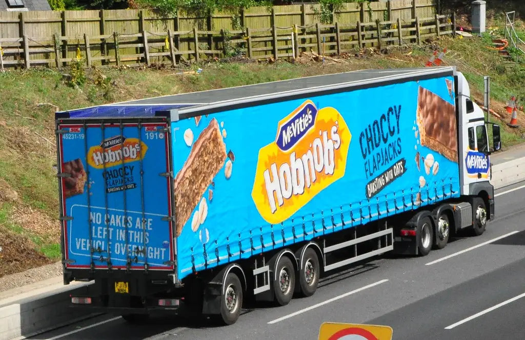 Truck with McVitie's Hobnobs advertising on a road