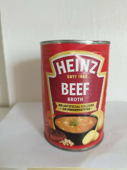 Can of Heinz Beef Broth with mild dent on a white surface