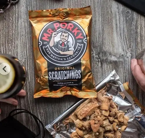 Packaged snack with 'Mr Porky' branding on a wooden surface