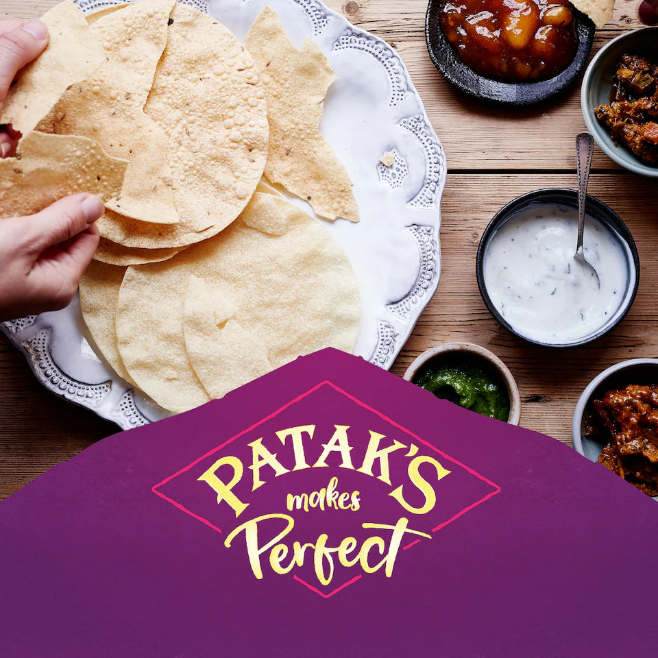 Tortilla chips on a plate with Patak's branding overlay