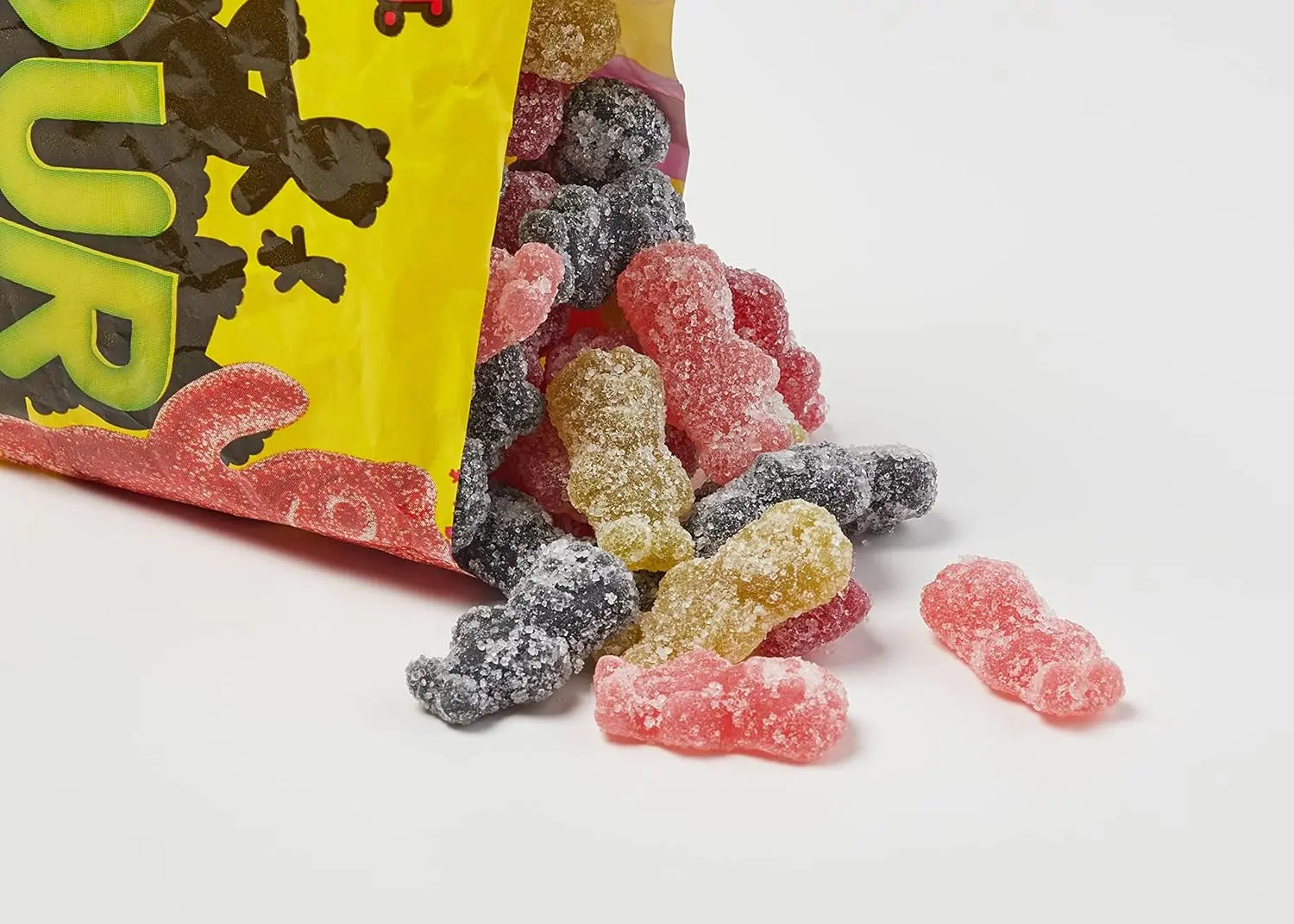 Colourful gummy candies spilling out of a bag with a white background