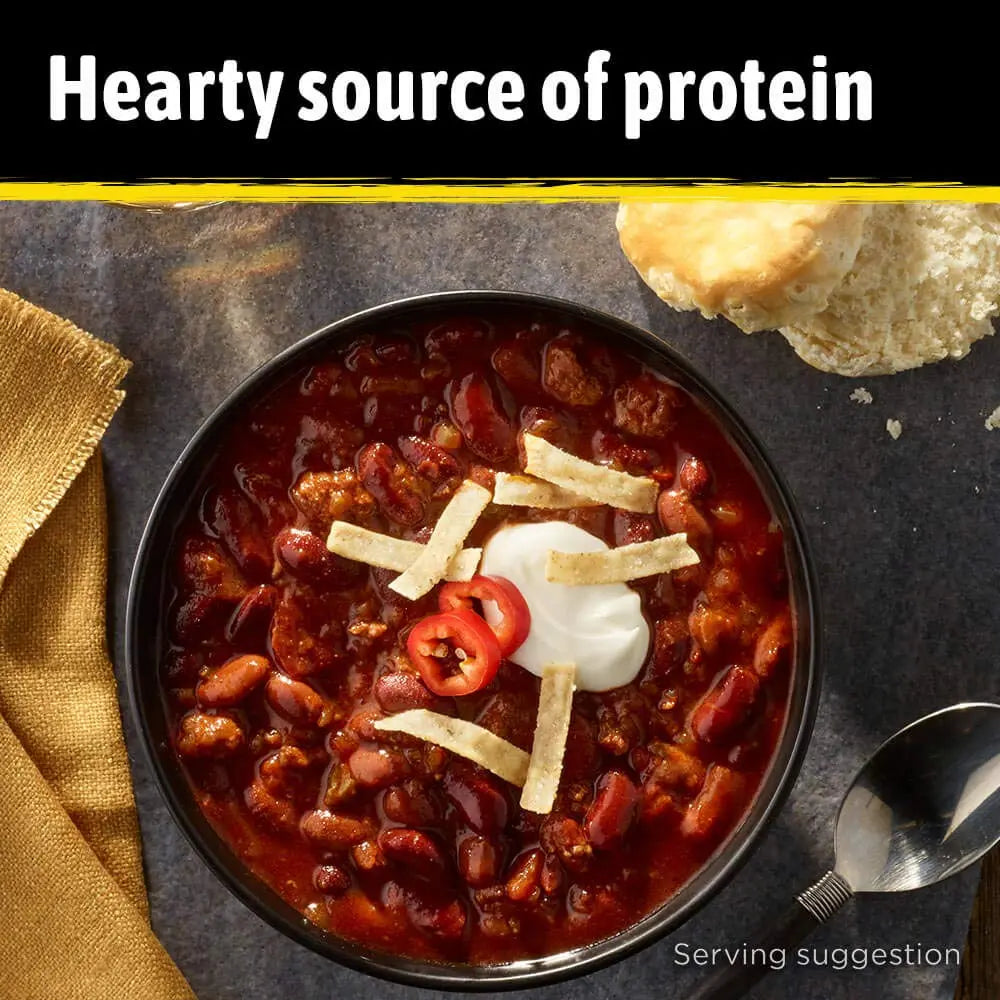 Bowl of chili with toppings on a dark surface, text 'Hearty source of protein'.