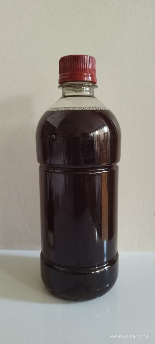 Bottle of Tesco Malt Vinegar with a red cap on a white background