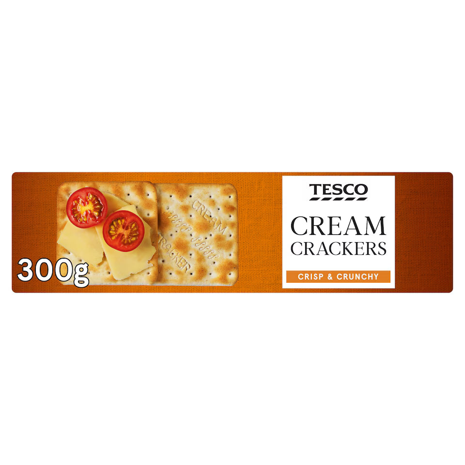 A 300g package of Tesco Cream Crackers, featuring a brown textured background with an illustration of square crackers topped with cheese and tomato slices, alongside the Tesco brand logo and product name.