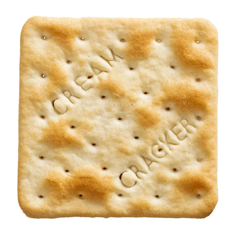 A single square cream cracker with embossed lettering reading 'CREAM CRACKER' and perforated holes, isolated on a white background.