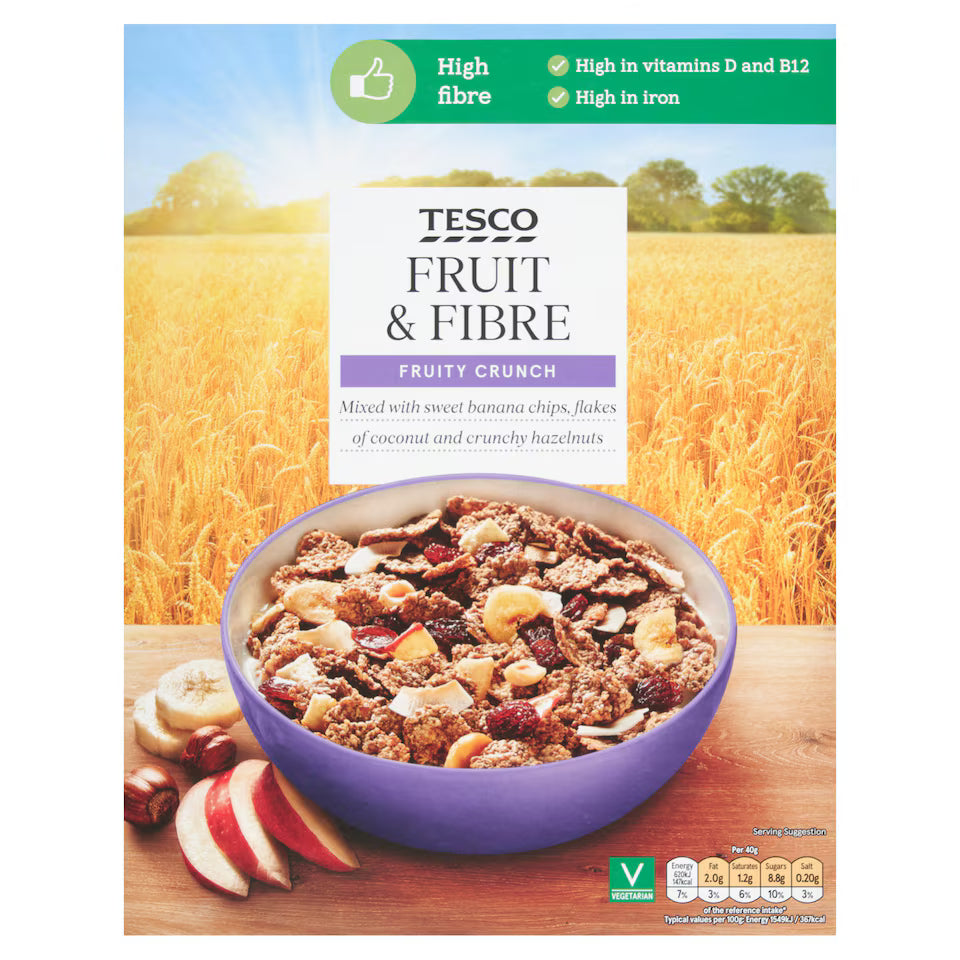 Tesco Fruit & Fibre cereal package with a bowl of cereal and fruit on a wooden surface.