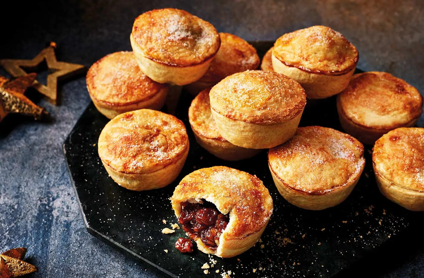 Baked pastries on a dark surface with a star-shaped object in the background