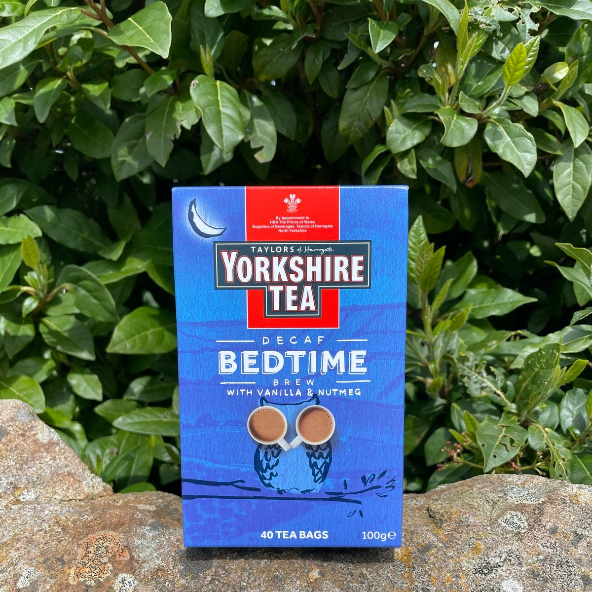 Yorkshire Tea Decaf Bedtime tea package on a stone surface with green foliage in the background